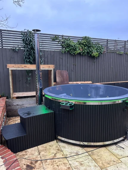 Brit Hot Tubs - Elevate Your Outdoor Oasis with the Luxurious LUXARA Deluxe Fiberglass Hot Tub Imagine stepping into a warm, bubbling retreat right in the comfort of your own backyard. Introducing the LUXARA Deluxe Fiberglass Hot Tub – a stunning 6-8 seater designed to elevate your outdoor living experience to new heights. Priced at £4,900 this hot tub is the epitome of relaxation and entertainment, offering the perfect space to create unforgettable moments with family and friends. Whether you're seeking a tranquil sanctuary for personal rejuvenation or a social hub for gathering with loved ones, the LUXARA is the ultimate investment in your well-being and outdoor lifestyle. LUXARA Deluxe Fiberglass Hot Tub - Spacious Comfort Step into the LUXARA's generous interior, boasting a diameter of 220 cm and an inside height of 90 cm. The ergonomic bench seating, with a height of 30 cm and width of 33 cm, ensures maximum comfort and support, allowing you to fully immerse yourself in the soothing waters. Premium Fiberglass Construction Crafted from high-quality fiberglass, the LUXARA hot tub exudes a sleek, durable finish that's both stylish and easy to maintain. Choose from a range of interior colors, including Blue, White/Cream, or Grey, to seamlessly blend with your outdoor decor. Efficient and Eco-Friendly Heating At the heart of the LUXARA lies a stainless steel wood-burning oven with a flue, providing efficient and sustainable heating. This impressive system allows you to enjoy warm, soothing waters quickly, without lengthy waiting times. Embrace the rustic charm of the wood-fired heating while contributing to a more eco-friendly lifestyle. LUXARA Deluxe Fiberglass Hot Tub - Therapeutic Hydrotherapy Immerse yourself in the LUXARA's advanced hydrotherapy features, designed to soothe and rejuvenate. Experience the gentle caress of 10-12 air jets, releasing soothing bubbles, and the targeted relief of 8 powerful hydro massage jets. Set the perfect ambiance with the single LED light, featuring 4 color options to enhance your relaxation. Customizable Aesthetics Personalize your LUXARA hot tub to reflect your unique outdoor style. Choose from Fired and Stained Grey or Brown wood cladding, made from premium Thermowood, to create a harmonious look. Elevate the visual appeal further with side artwork illuminated by LED lights, selecting from designs like a horse, palm, or forest tree. LUXARA Deluxe Fiberglass Hot Tub - Convenience and Comfort The LUXARA comes equipped with thoughtful features that prioritize your comfort and enjoyment. Relax under the insulated cover lid, which helps retain heat and keep your hot tub clean when not in use. Easily maintain crystal-clear water with the included filtration system, and keep your beverages close at hand with the convenient side drinks shelf. Unlock a Haven of Relaxation Elevate your outdoor living experience and transform your backyard into a private oasis of luxury and tranquility. The LUXARA Deluxe Fiberglass Hot Tub is more than just a purchase; it's an investment in your well-being, quality time with loved ones, and the creation of cherished memories. Don't settle for anything less than the ultimate in relaxation and entertainment. Order the LUXARA Deluxe Fiberglass Hot Tub today and unlock a world of unparalleled comfort and rejuvenation right in the comfort of your own home. LUXURA HOT TUB SPECIFICATIONS High quality fibreglass insert Wood cladding walls Internal wood fired heater  Internal width 205 cm  External width 225 cm  Capacity: 6-8 person Inside height 88 cm; External height 105 cm Water capacity: 1400 - 1500L Empty weight 250kg 2,5h – 3h heating time Insert insulated with polyurethane foam Glass heater door Stainless steel chimney 2m with a cap Chimney heat guard Hydro massage and air bubble system with 10 jets Air bubble system with 12 jets Underwater LED light 1 Mini LED lights  Exterior LED light stripe Insulated Thermo lid  2 drink holders - stainless steel Box stair Sand filter Stainless steel drain valve 40mm 24 months warranty Colour of fibreglass insert available : light blue, grey, light grey or cream Stainless steel wood burning oven ( AISI 304) 30 kW or (AISI 316) 30 kW Oven front colour: Stainless steel – Grey or Black Wall cladding: Pine Wood - thickness 20 mm, Thermo Wood - thickness 20 mm, UPVC - thickness 18mm, Cedar Wood - thickness 18 mm Wood cladding stain colours: Transparent Grey, Transparent Brown, Teak, and Black Insulated Thermo lid colours: grey or brown Do you have more QUESTIONS about LUXARA fibreglass hot tub? Contact our sales team now! Here you can find alternative hot tubs.
