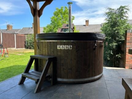 Brit Hot Tubs - Escape to Your Own Backyard Oasis with the ARCOS 3DG - Fiberglass 3D Granit Hot Tub Imagine stepping into a warm, soothing sanctuary in the comfort of your outdoor space. Introducing the ARCOS 3DG -  Fiberglass 3D Granit Hot Tub – a stunning 4-6 seater designed to transform your backyard into a personal oasis of luxury and relaxation. Priced at just £4,300 this exceptional hot tub offers unparalleled value, combining premium features and superior craftsmanship to create the ultimate spa-like experience. Whether you're seeking a tranquil retreat for personal rejuvenation or a gathering place to create cherished memories with family and friends, the ARCOS is the perfect addition to your outdoor living space. Compact Yet Spacious Design With a compact diameter of 180 cm and an inside height of 85 cm, the ARCOS 3DG hot tub provides ample space for everyone to unwind in total comfort. The ergonomic bench seating, featuring a height of 30 cm and a width of 33 cm, ensures maximum support and relaxation during your soak. ARCOS 3DG - Fiberglass 3D Granit Hot Tub - Premium Fiberglass Construction Crafted from high-quality fiberglass, the ARCOS hot tub boasts a sleek, modern finish that's not only visually stunning but also incredibly durable and easy to maintain. The included fiberglass cover lid adds an extra layer of protection, keeping your hot tub clean and energy-efficient when not in use. Elegant Wood Finishing Enhancing the natural beauty of the ARCOS 3DG hot tub is the elegant Pinewood cladding on the exterior, with a wall thickness of 20 mm. Available in sophisticated Grey or Brown finishes, this warm, wooden accent adds a touch of rustic charm and a harmonious blend of materials that will captivate all who lay their eyes on it. Customizable Aesthetics Personalize the look of your ARCOS 3DG hot tub by choosing from a range of interior colours – Blue, White/Cream, or Grey – to seamlessly complement your outdoor decor. This attention to detail allows you to create a truly bespoke oasis that reflects your personal style. ARCOS 3DG - Fiberglass 3D Granit Hot Tub - Efficient and Eco-Friendly Heating At the heart of the ARCOS 3DG lies a stainless steel wood-burning oven with a flue, providing efficient and sustainable heating. This impressive system allows you to enjoy warm, soothing waters quickly, without the long waiting times typically associated with hot tub heating. Embrace the rustic charm of wood-fired heating while contributing to a more eco-friendly lifestyle. Unparalleled Relaxation Immerse yourself in the ARCOS 3DG' generous 1,250-liter water capacity, offering a fully immersive experience that promotes deep relaxation and rejuvenation. Whether you're seeking a moment of solitude or quality time with loved ones, this hot tub is designed to soothe both your body and mind. Affordable Luxury The ARCOS Fiberglass Hot Tub offers exceptional value, providing a premium spa experience at a competitive price point. This makes it an excellent investment in your well-being and outdoor lifestyle, allowing you to enjoy the luxury of a hot tub without breaking the bank. Create Your Personal Oasis of Relaxation Elevate your outdoor living experience and transform your backyard into a haven of luxury and tranquility. The ARCOS 3DG - Fiberglass 3D Granit Hot Tub is more than just a purchase; it's an investment in your personal wellness, quality time with loved ones, and the creation of cherished memories that will last a lifetime. Don't settle for anything less than the ultimate in relaxation and entertainment. Order the ARCOS 3D Granit - Fiberglass 3D Granit Hot Tub today and unlock a world of unparalleled comfort and rejuvenation right in the comfort of your own home. ARCOS 3DG - Fibreglass 3D Granit HOT TUB SPECIFICATIONS High-quality fibreglass insert Wood cladding walls Internal wood-fired heater  Internal width 180 cm  External width 200 cm  Capacity: 4-6 person Inside height 88 cm; External height 105 cm Water capacity: 1200 - 1300L Empty weight 200kg 1,5h – 2h heating time Insert insulated with polyurethane foam Glass heater door Stainless steel chimney 2m with a cap Chimney heat guard Hydro massage and air bubble system with 8 jets Air bubble system with 12 jets Underwater LED light 1  Exterior LED light stripe Insulated Thermo lid  2 drink holders - stainless steel Box stair Stainless steel drain valve 40mm 24 months warranty Colour of fibreglass insert available: light blue, grey, light grey or cream Stainless steel wood burning oven ( AISI 304) 30 kW or (AISI 316) 30 kW Oven front colour: Stainless steel – Grey or Black Wall cladding: Pine Wood - thickness 20 mm, Thermo Wood - thickness 20 mm, UPVC - thickness 18mm, Cedar Wood - thickness 18 mm Wood cladding stain colours: Transparent Grey, Transparent Brown, Teak, and Black Insulated Thermo lid colours: grey or brown Do you have more QUESTIONS about ARCOS fibreglass hot tub? Contact our sales team now! Here you can find alternative hot tubs.