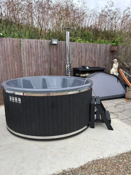 Brit Hot Tubs - Introducing the VISTARA Deluxe Acrylic Hot Tub 2.2m 6-8 Seater Elevate your outdoor living experience with the VISTARA Deluxe Acrylic Hot Tub, a luxurious sanctuary designed to comfortably accommodate 6-8 people. Priced at £4,900 this hot tub combines elegance, advanced features, and superior British craftsmanship to offer you the ultimate relaxation experience right in your backyard. VISTARA Deluxe Acrylic Hot Tub Key Features and Specifications - Spacious and Ergonomic Design Internal Diameter: 204 cm wide - External Diameter: 225 cm wide - Inside Height: 88 cm - External Height: 100 cm - Bench Height: 27 cm - Bench Width: 36 cm - Water Capacity: 1,500 - 1,700 litres - Weight: 240 kg - Heating Time: Heats up in 2 to 2.5 hours Premium Acrylic Construction: - Colours of Insert Available: Grey, Blue, White, Gold - Durable and easy to maintain, the acrylic interior offers a sleek and modern finish. - Powerful Heating System: - External Integrated Wood-Burning Oven: - Made of AISI 316 stainless steel with a 30kW output - Oven Depth: 56 cm - Oven Front Colours: Stainless Steel, Grey, or Black - Glass Heater Door: Allows you to monitor the fire easily - Stainless Steel Chimney: 2 meters tall with a cap and heat guard for safe and efficient ventilation - Advanced Hydrotherapy Features: - Hydro Massage Jets: 10 jets provide a powerful massage to soothe muscles - Air Bubble System: 12 jets create a relaxing bubble massage - LED Lighting: - 4 main LED lights illuminate the water - Mini LED lights inside & outside enhance the ambiance - Headrests: 6 comfortable headrests for added relaxation - Efficient Filtration and Maintenance: - Sand Filter System: Keeps the water crystal clear with minimal effort - High Flow Drain Tap: Allows for quick and easy draining - Thermo Cover: Insulated cover retains heat and keeps the tub clean when not in use -  Customizable Aesthetics: - Wood Cladding Stain Colours: Choose from Light Grey, Dark Grey, Light Brown, Dark Brown, or Black to match your outdoor decor Why Choose the VISTARA Deluxe Hot Tub? Unmatched Luxury and Comfort: The spacious interior and ergonomic seating ensure that you and your guests can relax in complete comfort. - Advanced Therapeutic Features: The combination of hydro massage and air bubble jets provides a spa-like experience that promotes relaxation and well-being. - Efficient and Eco-Friendly Heating: The AISI 316 stainless steel wood-burning oven is not only powerful but also resistant to corrosion, ensuring longevity and optimal performance. - Elegant Design: High-quality acrylic inserts and customizable wood cladding allow you to personalize your hot tub to suit your style. - Enhanced Ambiance: LED lighting systems create a captivating atmosphere, perfect for evening soaks and entertaining guests. - Easy Maintenance: The sand filter system and high flow drain tap make keeping your hot tub clean and ready to use simple and hassle-free. Invest in Your Well-Being Today Imagine ending each day with a soothing soak in the VISTARA Deluxe Acrylic Hot Tub, surrounded by warm water, gentle bubbles, and soft lighting. It's more than just a hot tub—it's a retreat, a place where you can unwind, rejuvenate, and create cherished memories with loved ones. Don't miss the opportunity to transform your outdoor space into a haven of relaxation and luxury. Order the VISTARA Deluxe Acrylic Hot Tub today and take the first step toward enhancing your lifestyle and well-being. Imagine transforming your outdoor space into a luxurious haven of relaxation - that's the promise of the VISTARA Deluxe Acrylic Hot Tub. This magnificent 6-8 person hot tub, priced at £7,890.00, combines advanced features, elegant design, and superior British craftsmanship to elevate your backyard experience. Key Features and Specifications: Spacious and Ergonomic Design: With an internal diameter of 204 cm, external diameter of 225 cm, and inside height of 88 cm, this hot tub offers ample room for you and your guests to relax in comfort. The 27 cm high, 36 cm wide benches provide ergonomic support, while the 1,500 - 1,700 litre water capacity ensures a truly immersive soak. Premium Acrylic Construction: The durable, easy-to-maintain acrylic interior comes in a choice of Grey, Blue, White, or Gold to suit your style. Powerful Heating System: An AISI 316 stainless steel, 30kW wood-burning oven heats the tub in just 2 to 2.5 hours, while the 2 meter stainless steel chimney ensures safe, efficient ventilation. Advanced Hydrotherapy Features: Relax and unwind with 10 hydro massage jets and 12 air bubble jets, all illuminated by 4 main LED lights and mini LED lights for a truly spa-like experience. Six comfortable headrests add the perfect finishing touch. Efficient Filtration and Maintenance: The sand filter system keeps the water crystal clear, while the high flow drain tap and insulated thermo cover make maintaining your hot tub a breeze. Customizable Aesthetics: Choose from Light Grey, Dark Grey, Light Brown, Dark Brown, or Black wood cladding to seamlessly integrate the hot tub into your outdoor décor. Why Choose the VISTARA Deluxe Hot Tub? Unmatched Luxury and Comfort: This spacious, ergonomically designed hot tub ensures you and your guests can comfortably relax. Advanced Therapeutic Features: The hydro massage and air bubble jets provide a truly indulgent spa-like experience, promoting relaxation and well-being. Efficient and Eco-Friendly Heating: The powerful, corrosion-resistant wood-burning oven heats the tub quickly and sustainably. Elegant Design: Personalize your hot tub with acrylic inserts and wood cladding to complement your outdoor space. Enhanced Ambiance: Captivating LED lighting creates a soothing, inviting atmosphere for evening soaks and entertaining. Easy Maintenance: Enjoy a hassle-free hot tub experience with the sand filter system and high-flow drain tap. Elevate your outdoor living and invest in your well-being with the VISTARA Deluxe Acrylic Hot Tub. Imagine ending each day with a soothing soak, surrounded by warm water, gentle bubbles, and soft lighting - it's more than just a hot tub, it's a personal sanctuary where you can unwind, rejuvenate, and create cherished memories with loved ones. Don't miss the opportunity to transform your outdoor space into a haven of relaxation and luxury. Order the VISTARA Deluxe Acrylic Hot Tub today. VISTARA HOT TUB SPECIFICATIONS High quality acrylic insert Wood cladding walls Integrated wood fired heater  Internal width 185 cm  External width 220 cm  Capacity: 6-8 person Inside height 88 cm; External height 105 cm Water capacity: 1300-1400 L Empty weight 200kg 1.5h – 2h heating time Insert insulated with polyurethane foam Glass heater door Stainless steel chimney 2m with a cap Chimney heat guard Hydro massage and air bubble system with 10 jets Air bubble system with 12 jets Underwater MINI LED lights Exterior LED light stripe Insulated Thermo lid  2 drink holders - stainless steel Box stair Sand filter Stainless steel drain valve 40mm 24 months warranty Colour of ergonomic acrylic insert available: Grey, Beige, White Stainless steel wood burning oven ( AISI 304) 30 kW or (AISI 316) 30 kW Oven front colour: Stainless steel – GREY, or Stainless steel - BLACK Wall cladding: Pine Wood - thickness 20 mm, Thermo Wood - thickness 20 mm, UPVC - thickness 18mm, Cedar Wood - thickness 18 mm Wood cladding stain colours: Transparent Grey, Transparent Brown, Teak, and Black Insulated Thermo lid colours: grey or brown Do you have more QUESTIONS about VISTARA acrylic hot tub? Contact our sales team now! Here you can find alternative hot tubs.