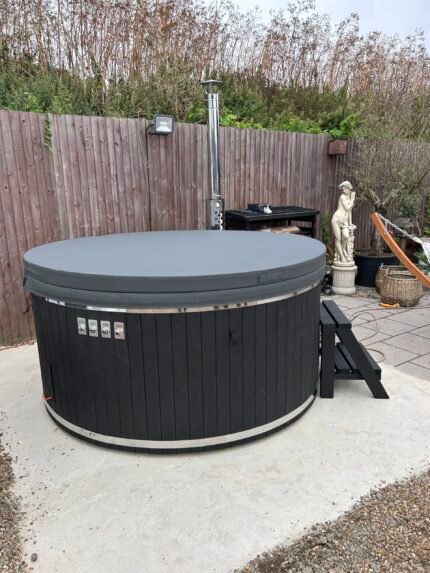 Brit Hot Tubs - Indulge in Luxury with the VIVORA 3DG - Fiberglass 3D Granit Hot Tub Imagine stepping into a warm, soothing sanctuary right in the heart of your backyard. Introducing the VIVORA 3DG - Fiberglass 3D Granit Hot Tub – a stunning 6-8 seater designed to elevate your outdoor living experience to new heights of luxury and relaxation. Priced at just £4,500 this exceptional hot tub offers unparalleled value, combining premium features and superior craftsmanship to create the ultimate spa-like retreat. Whether you're seeking a tranquil oasis for personal rejuvenation or a gathering place to create cherished memories with family and friends, the VIVORA 3DG is the perfect addition to your outdoor living space. VIVORA 3DG - Fiberglass 3D Granit Hot Tub - Spacious and Comfortable Design Boasting an impressive external diameter of 226 cm and an inside height of 85 cm, the VIVORA 3DG hot tub provides ample space for everyone to unwind in total comfort. The ergonomic bench seating, featuring a height of 30 cm and a width of 33 cm, ensures maximum support and relaxation during your soak. Premium Fiberglass Construction Crafted from high-quality fiberglass, the VIVORA 3DG hot tub exudes a sleek, modern finish that's not only visually stunning but also incredibly durable and easy to maintain. Elevate the aesthetic further with your choice of Blue, White/Cream, or Grey interior colours to seamlessly complement your outdoor decor. Elegant Wood Finishing Enhancing the natural beauty of the VIVORA 3DG hot tub is the elegant Pinewood cladding on the exterior, with a wall thickness of 20 mm. This warm, wooden accent adds a touch of rustic charm and a harmonious blend of materials that will captivate all who lay eyes on it. Efficient and Eco-Friendly Heating At the heart of the VIVORA 3DG lies a stainless steel wood-burning oven with a flue, providing efficient and sustainable heating. This impressive system allows you to enjoy warm, soothing waters quickly, without the long waiting times typically associated with hot tub heating. Embrace the rustic charm of wood-fired heating while contributing to a more eco-friendly lifestyle. Unparalleled Relaxation Immerse yourself in the VIVORA 3DG's generous 1,650-liter water capacity, offering a fully immersive experience that promotes deep relaxation and rejuvenation. Whether you're seeking the gentle caress of the air bubble jets or the targeted relief of the hydrotherapy massage, the VIVORA 3DG is designed to soothe both your body and mind. Affordable Luxury The VIVORA 3DG - Fiberglass 3D Granit Hot Tub offers exceptional value, providing a premium spa experience at a competitive price point. This makes it an excellent investment in your well-being and outdoor lifestyle, allowing you to enjoy the luxury of a hot tub without breaking the bank. VIVORA 3DG - Fiberglass 3D Granit Hot Tub - Create Your Backyard Oasis Elevate your outdoor living experience and transform your backyard into a haven of luxury and tranquillity. The VIVORA 3DG - Fiberglass 3D Granit Hot Tub is more than just a purchase; it's an investment in your wellness, quality time with loved ones, and the creation of cherished memories that will last a lifetime. Don't settle for anything less than the ultimate in relaxation and entertainment. Order the VIVORA Fiberglass Hot Tub today and unlock a world of unparalleled comfort and rejuvenation right in the comfort of your own home. VIVORA 3DG - Fiberglass 3D Granit HOT TUB SPECIFICATIONS High-quality fibreglass insert Wood cladding walls Internal wood-fired heater  Internal width 205 cm  External width 225 cm  Capacity: 6-8 person Inside height 88 cm; External height 105 cm Water capacity: 1400 - 1500L Empty weight 250kg 2h – 2,5h heating time Insert insulated with polyurethane foam Glass heater door Stainless steel chimney 2m with a cap Chimney heat guard Hydro massage and air bubble system with 10 jets Air bubble system with 12 jets Underwater LED light 1  Exterior LED light stripe Insulated Thermo lid  2 drink holders - stainless steel Box stair Stainless steel drain valve 40mm 24 months warranty Colour of fibreglass insert available: light blue, grey, light grey or cream Stainless steel wood burning oven ( AISI 304) 30 kW or (AISI 316) 30 kW Oven front colour: Stainless steel – Grey or Black Wall cladding: Pine Wood - thickness 20 mm, Thermo Wood - thickness 20 mm, UPVC - thickness 18mm, Cedar Wood - thickness 18 mm Wood cladding stain colours: Transparent Grey, Transparent Brown, Teak, and Black Insulated Thermo lid colours: grey or brown Do you have more QUESTIONS about VIVORA fibreglass hot tub? Contact our sales team now! Here you can find alternative hot tubs.